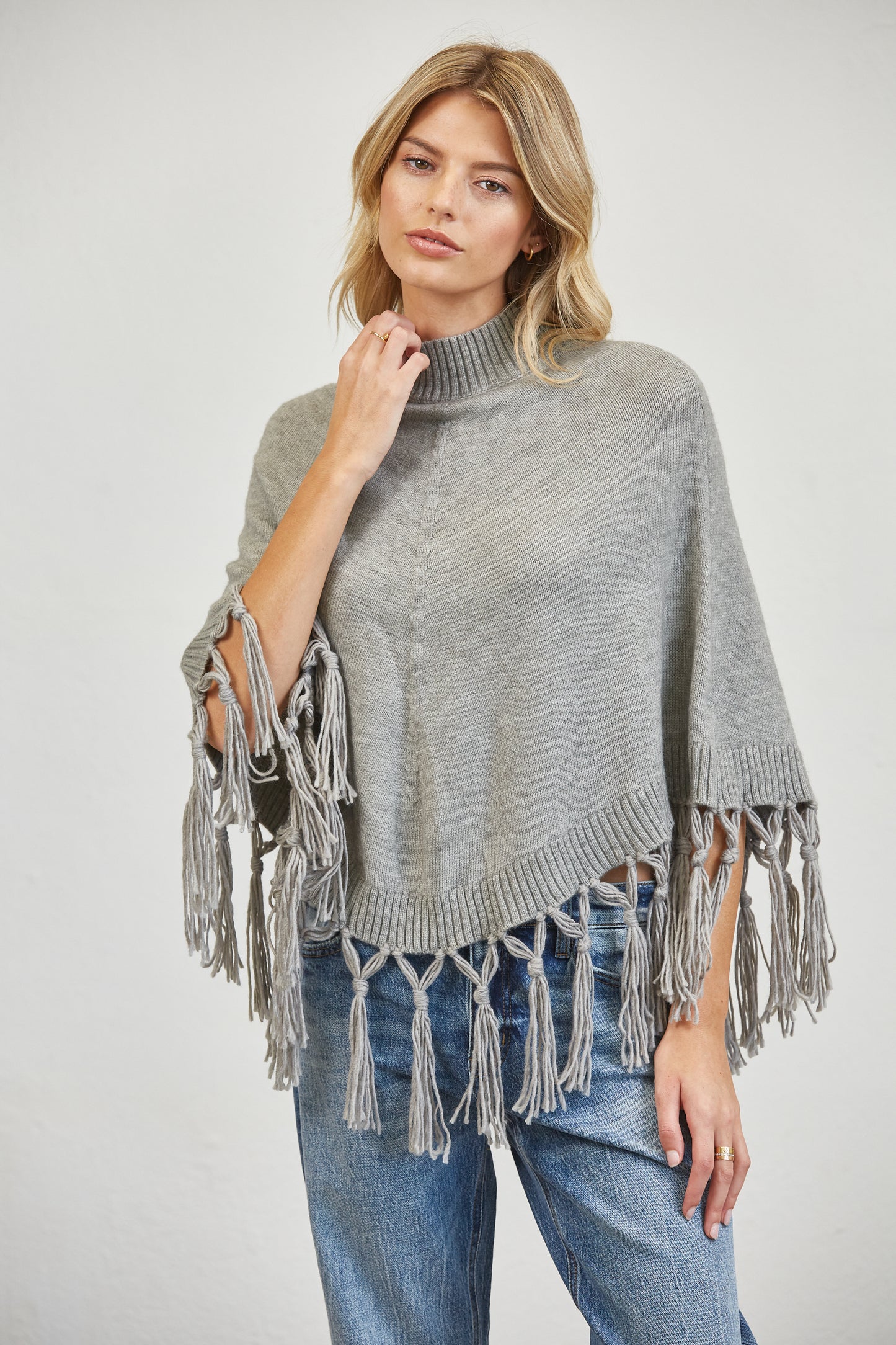 FRINGE MOCK NECK KNIT PANCHO SWEATER