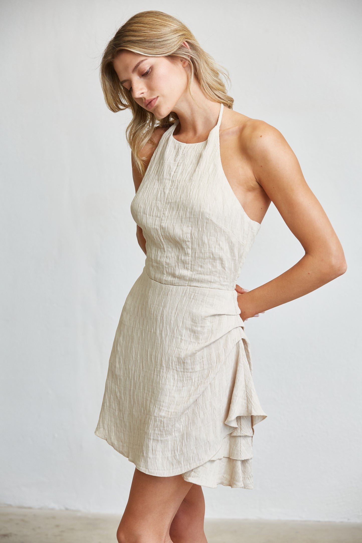 TEXTURED HALTER MINI DRESS WITH RUFFLE DETAIL